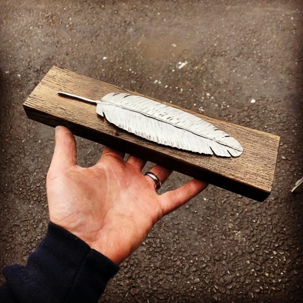 Lucky Feather on wood