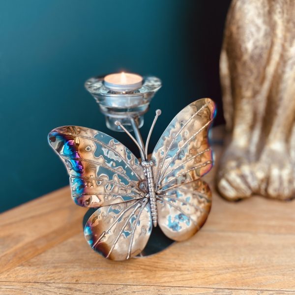 Candlelight dances within this beautiful metal butterfly sculpture.