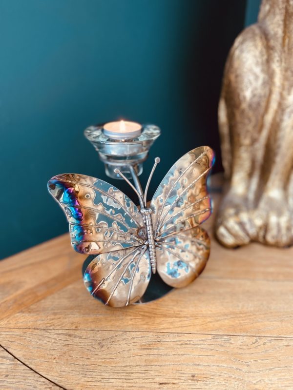 Candlelight dances within this beautiful metal butterfly sculpture.