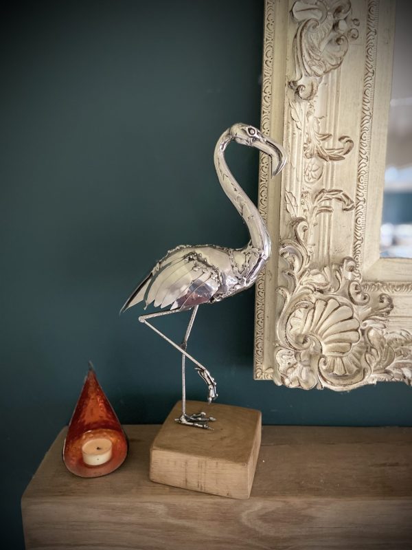 Flamingo sculpture on wood