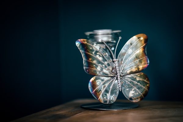 Light takes flight: a metal butterfly candle holder sculpture.